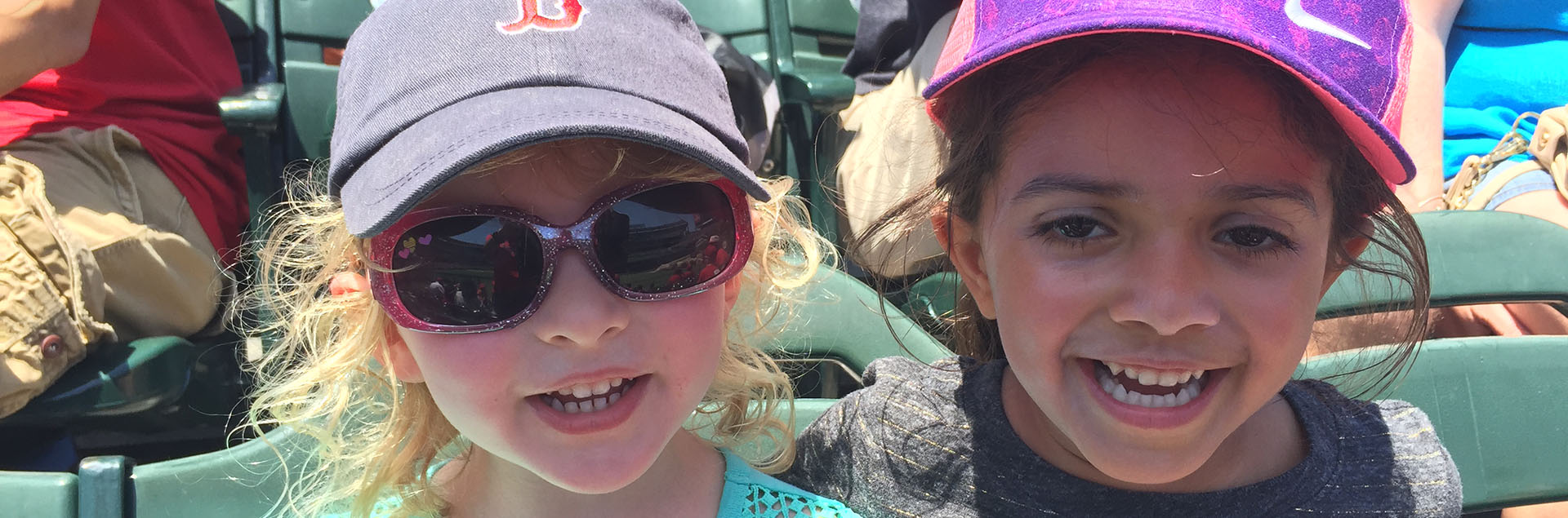 Little girls in stands at baseball game